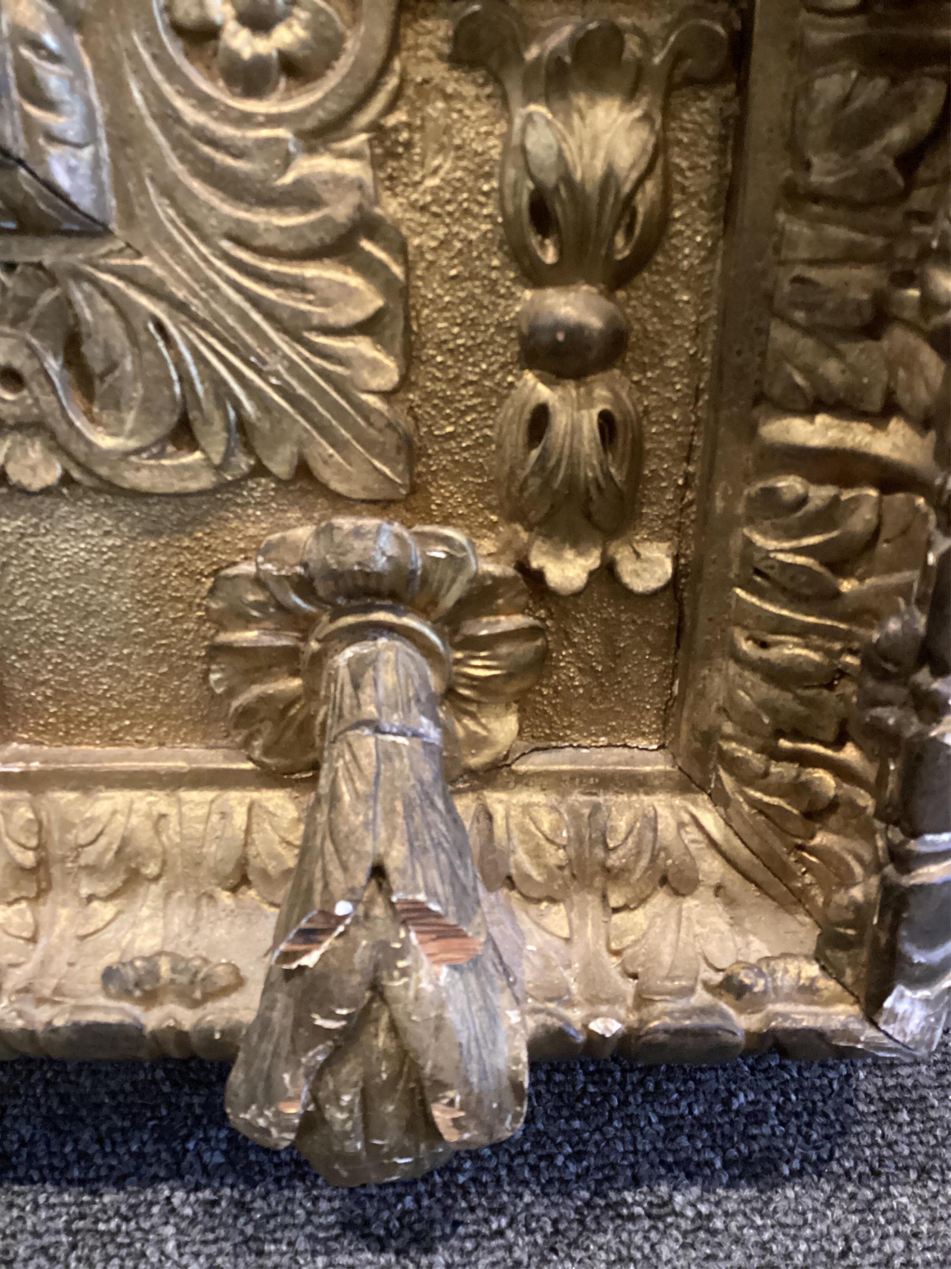 A late 19th century French carved gilt wood and composition overmantel mirror